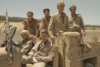 Cast sat in a military vehicle for SAS Rogue Heroes