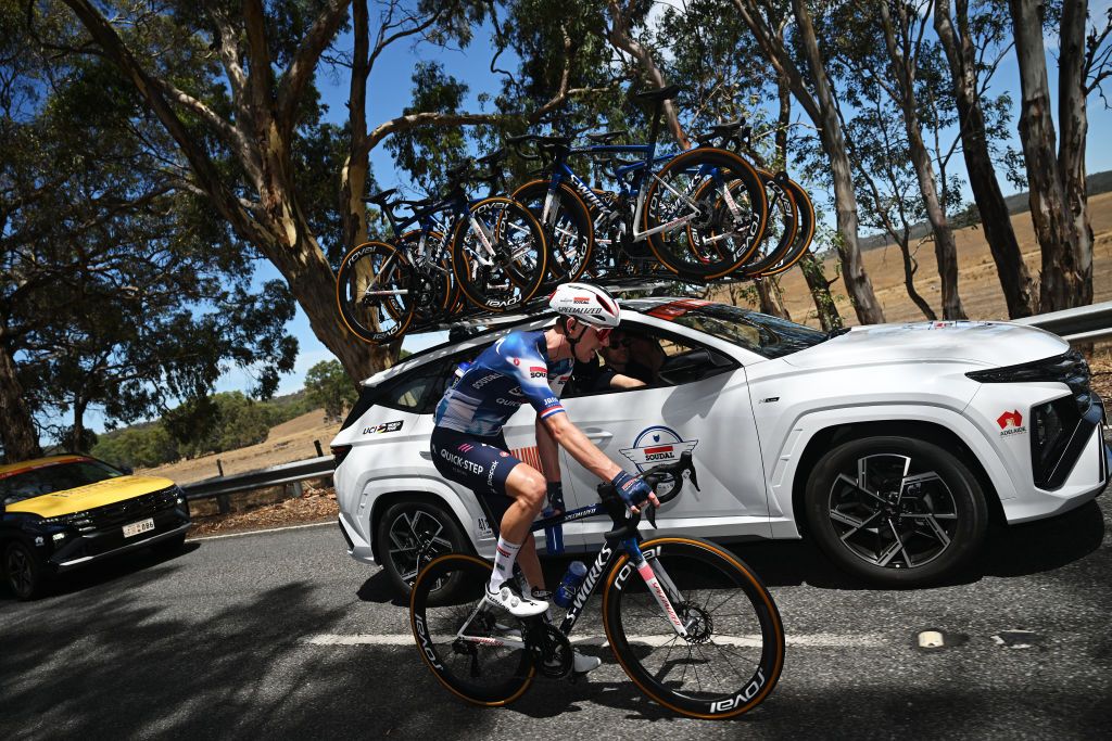 Pascal Eenkhoorn collecting bidons from the Soudal-Quickstep team car at the Tour Down Under