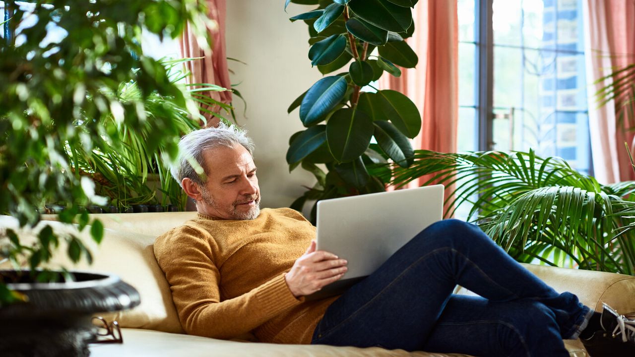 man sitting on the sofa with his laptop