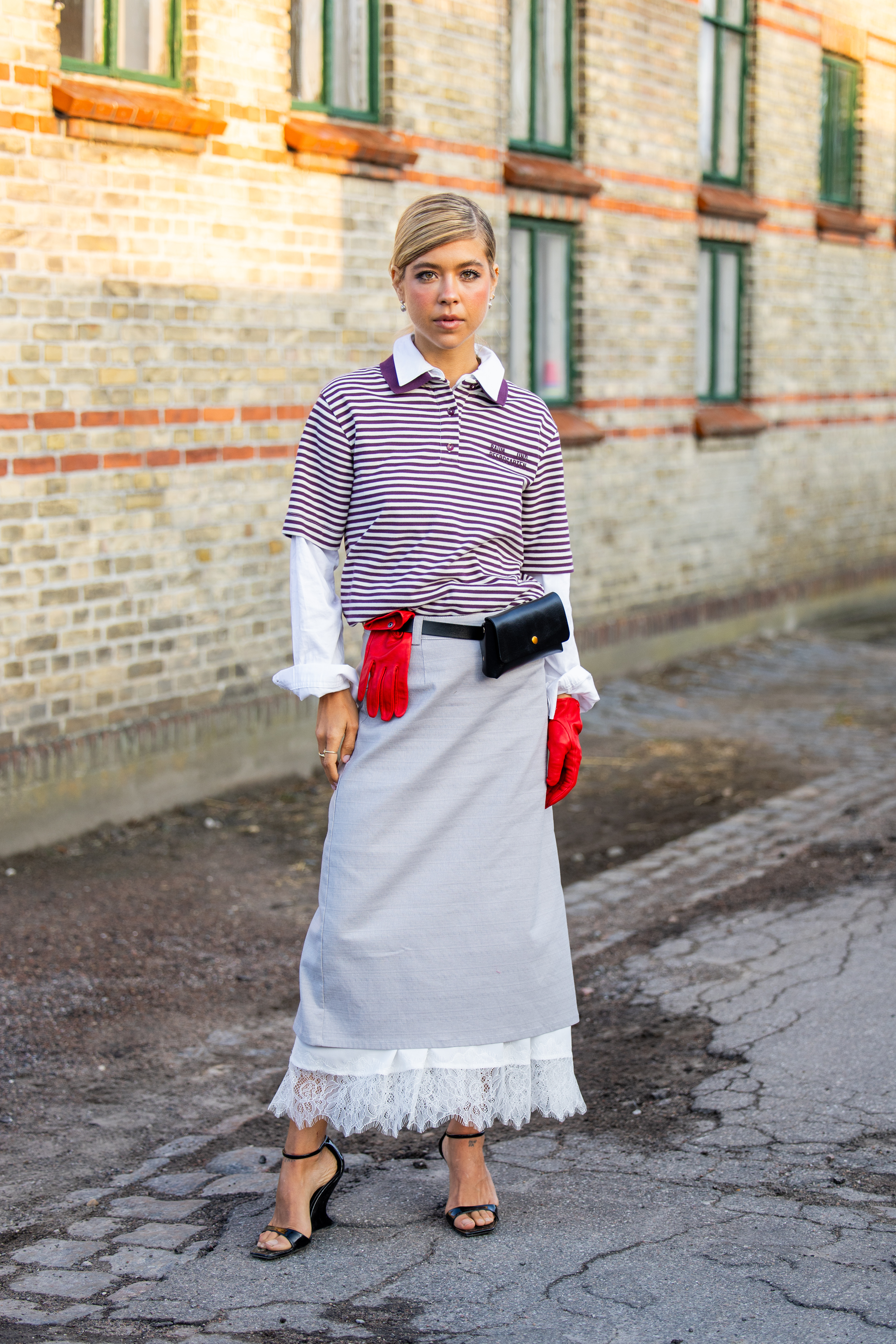 Woman in striped polo and lace-trimmed skirt