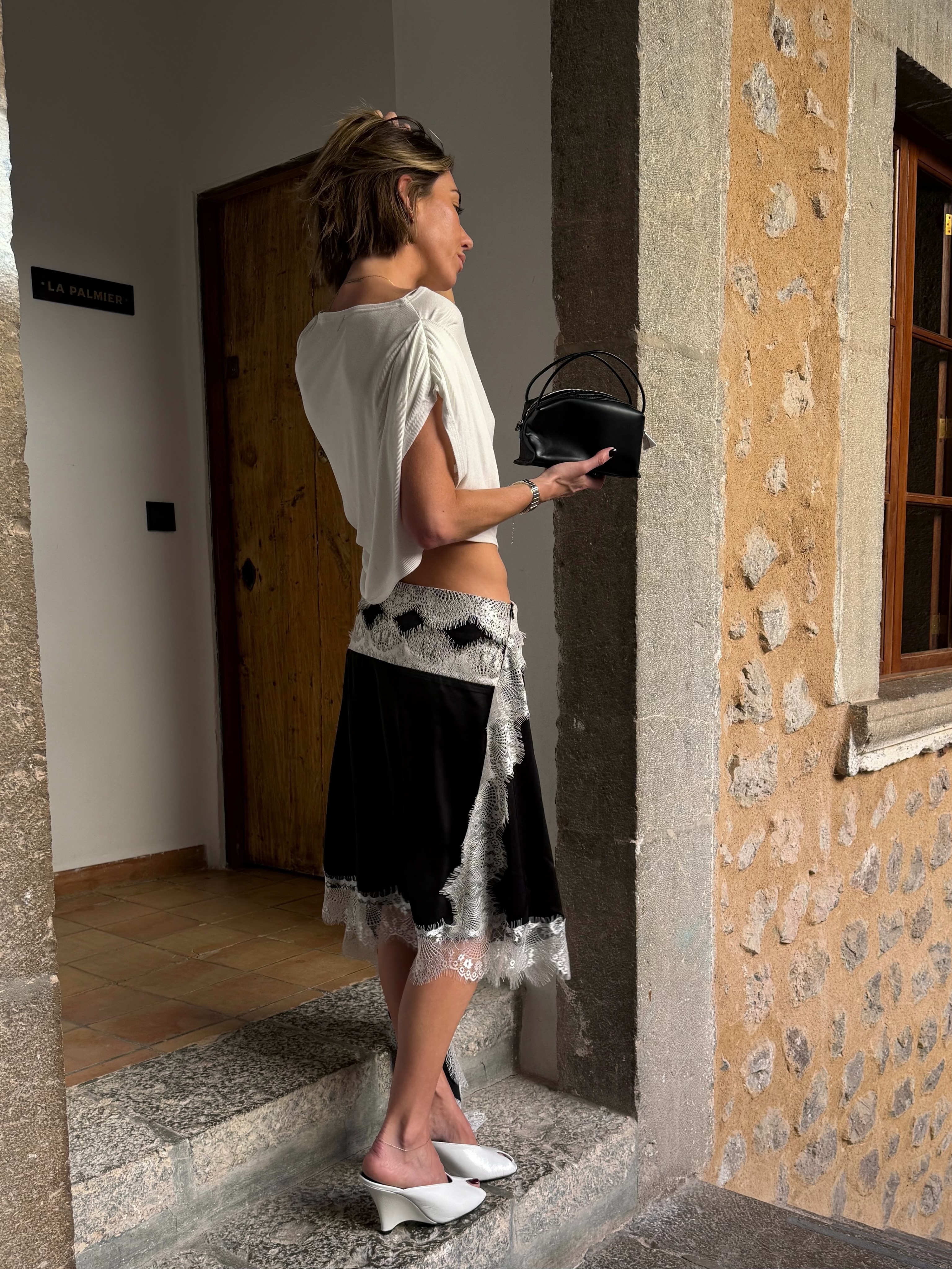 An image of a woman wearing skinny wedge sandals