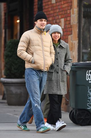 A photo of Olivia Rodrigo and Louis Partridge bundling up in matching winter coats and sneakers in New York City on Jan. 15