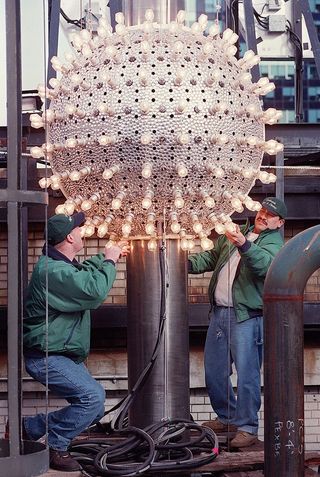 Workers check lightbulbs on the New Year's Eve Ball in Times Square 30 December 1998