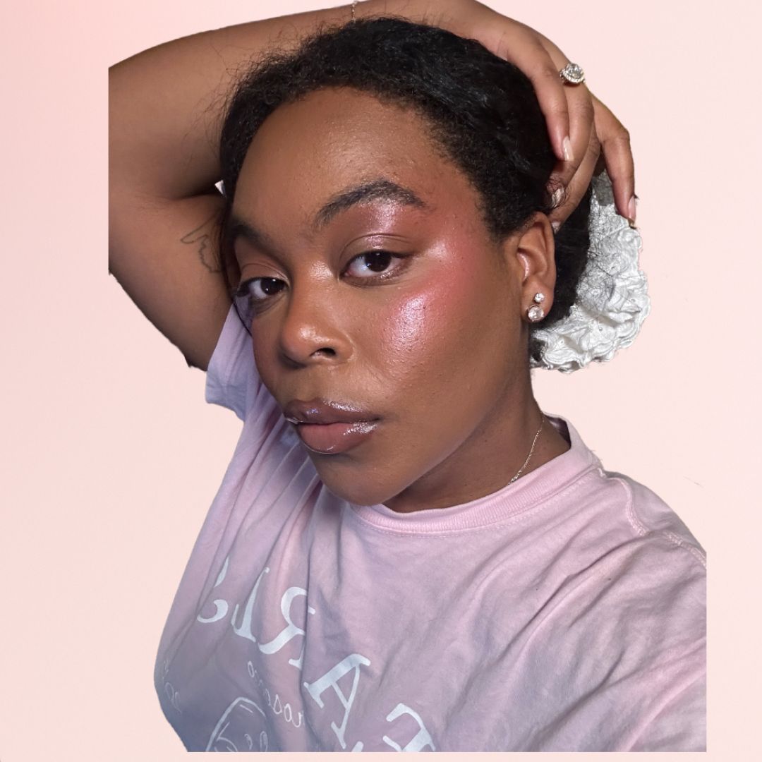 An image of Ariel Baker wearing blush and surrounded by blush makeup products
