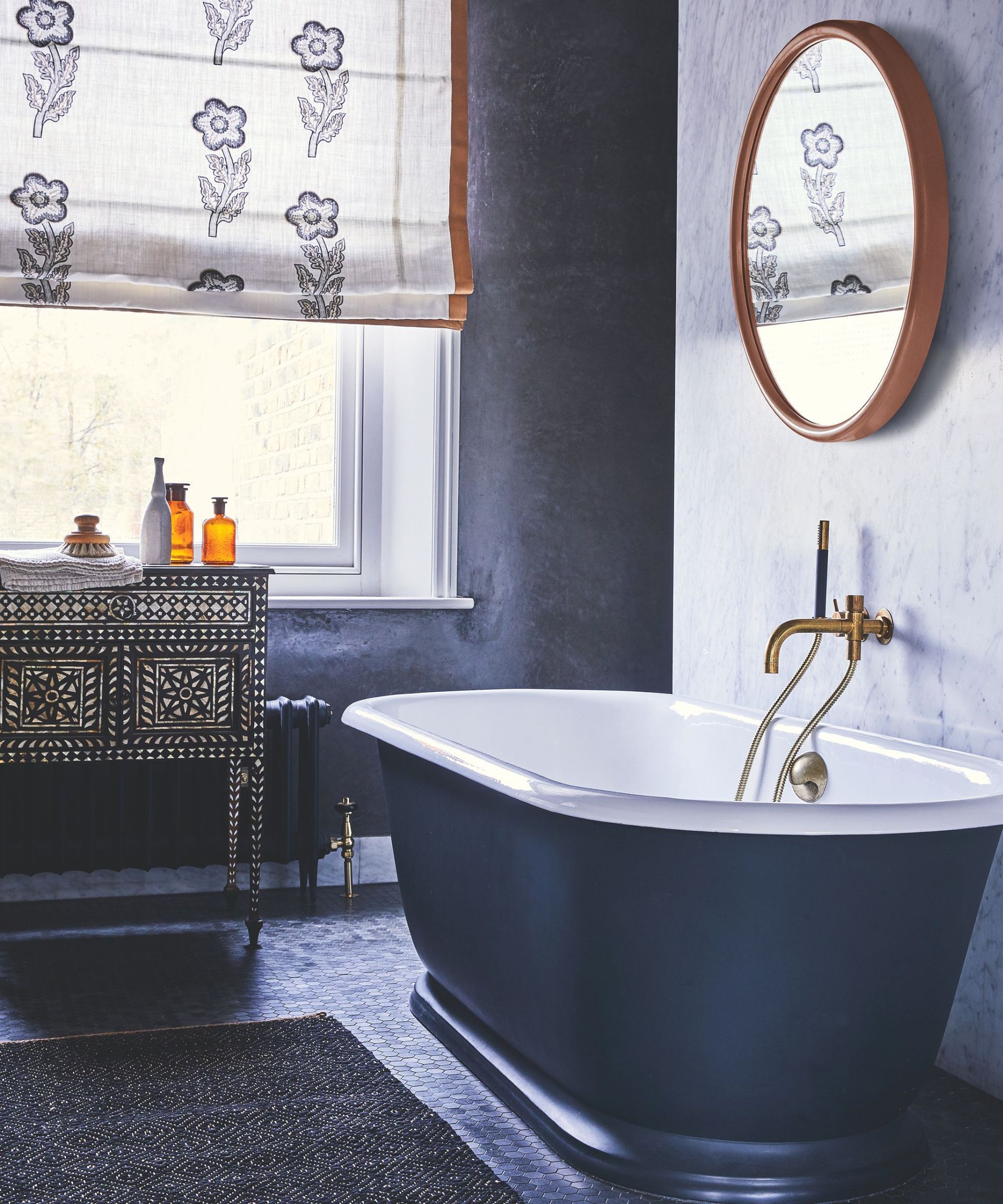A blue bathroom with a blue painted bathtub