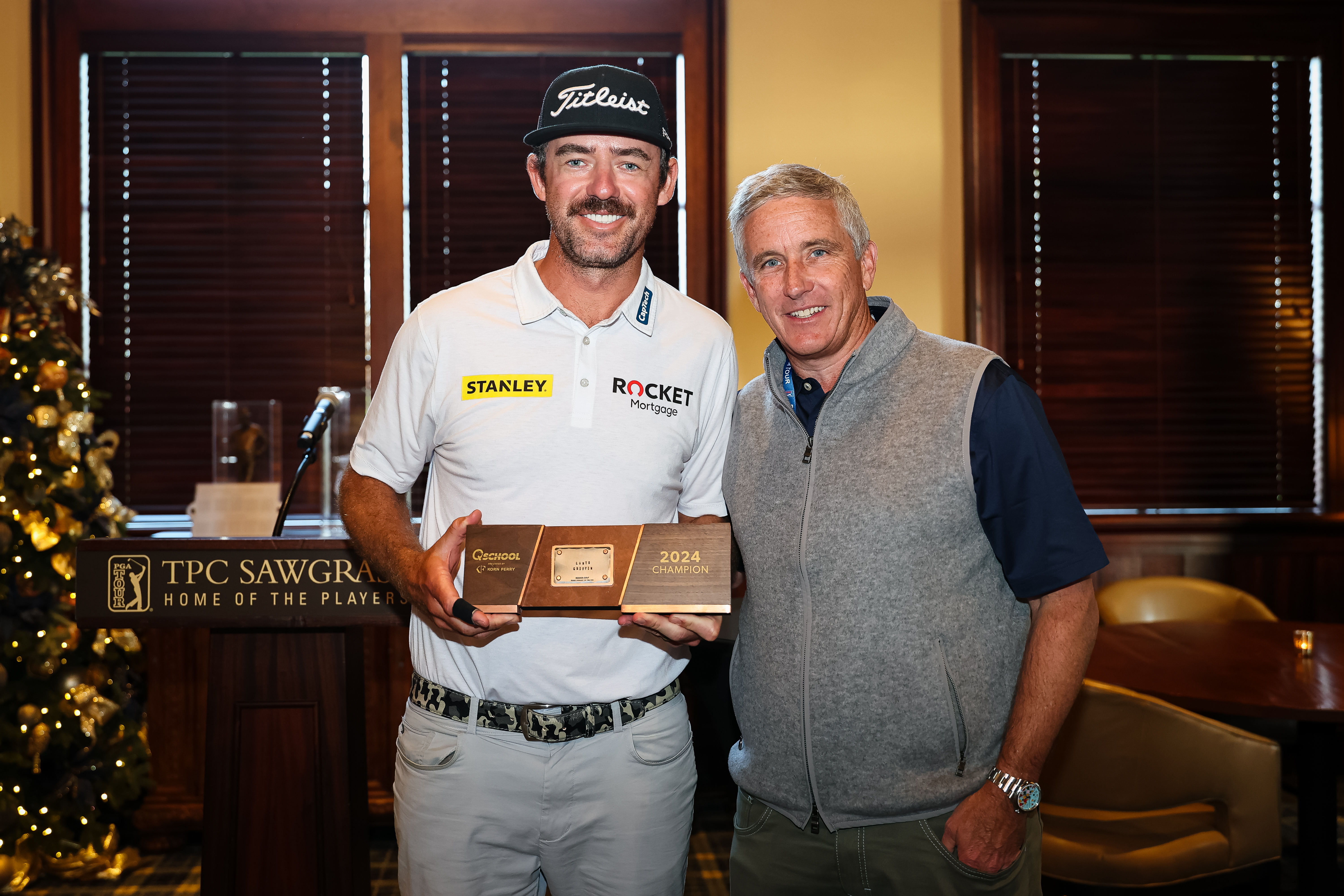 Lanto Griffin and Jay Monahan pose with the Q-School trophy