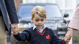 topshot britains prince george c accompanied by britains prince william l, duke of cambridge arrives for his first day of school at thomass school where he is met by helen haslem r head of the lower school in southwest london on september 7, 2017 afp photo pool richard pohle photo credit should read richard pohleafp via getty images