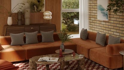 Brick and wood living room with warm orange, brown and white theme. There is a brown and white large area checkered rug and brown and cream checkered throw pillows on orange sofas, plus, mid century wooden sideboard, and a rounded marble table