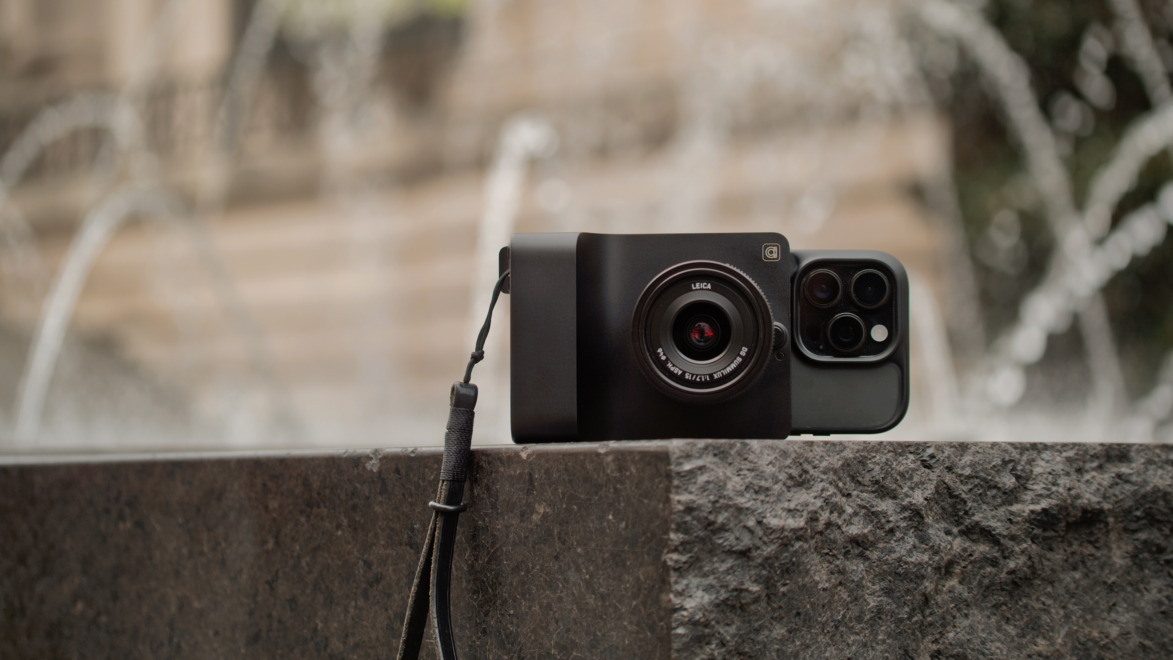 The Camera Intelligence Caira AI camera attached to an iPhone on a ledge