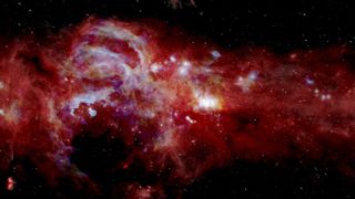 A composite image shows infrared light from swirls of gas and dust at the center of the Milky Way.
