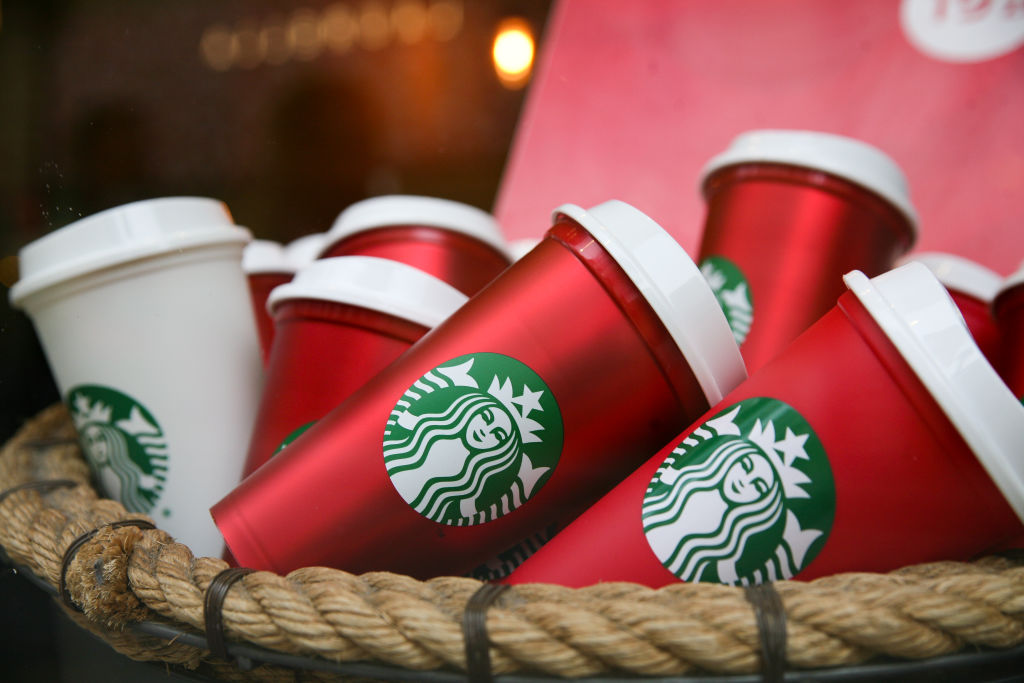 The Starbucks coffee shop logo on red cups. 