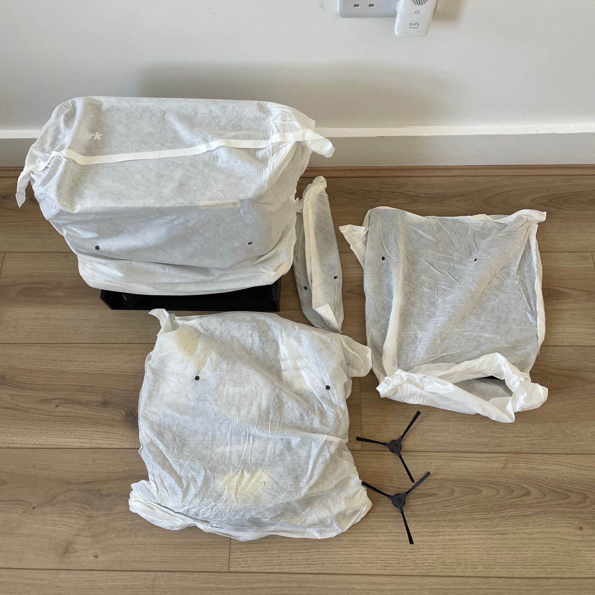 Shark PowerDetect NeverTouch components wrapped in paper on the floor