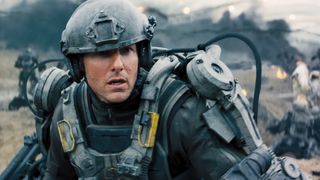 Tom Cruise as Major William Cage on the battlefield during Edge of Tomorrow, one of the best Netflix sci-fi movies out right now.