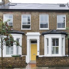 house exterior with bricked wall and white window