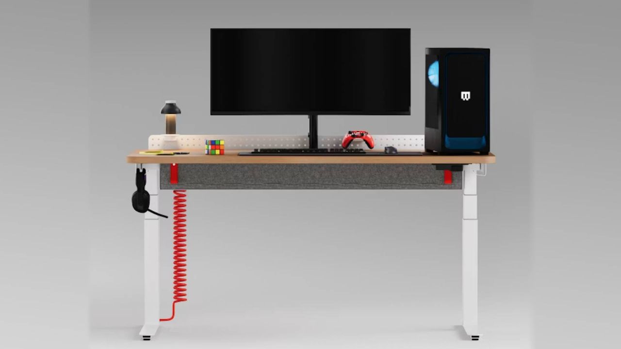Herman Miller Coyl gaming desk in white with PC and monitor on top.