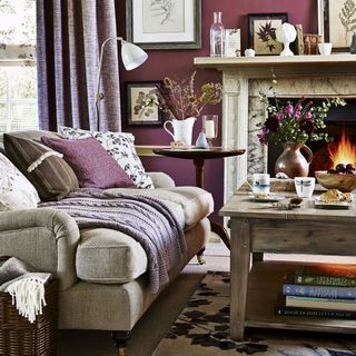 purple living room with fire place and wooden table