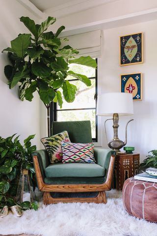 A living room nook with an accent chair and houseplants
