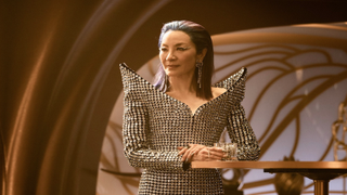 A woman in a glittery gown aboard a space station