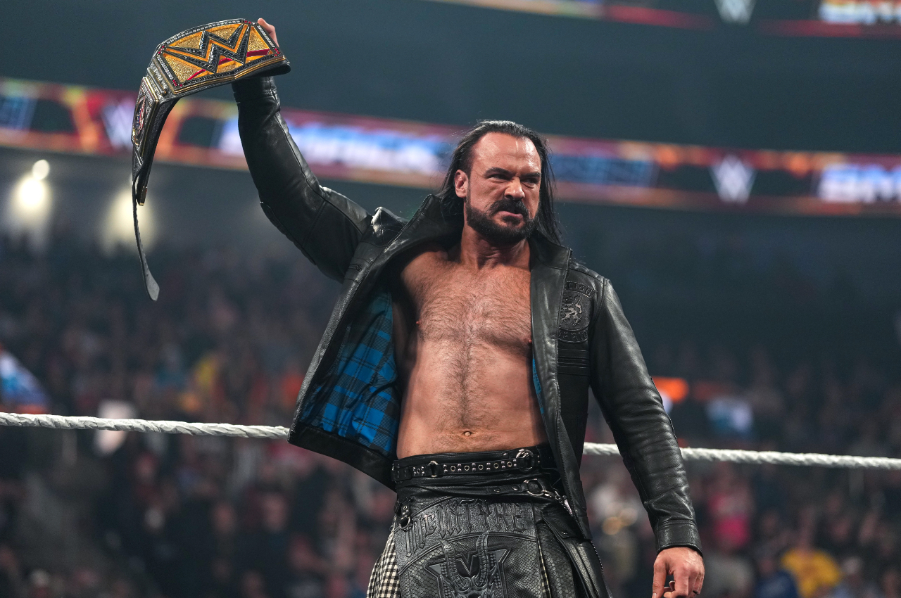 Drew McIntyre looking angry as he holds up the WWE title