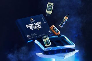 illustration of four bottles of condiments floating out of a blue cooler, along with a blue sign that says "bring taste to space"