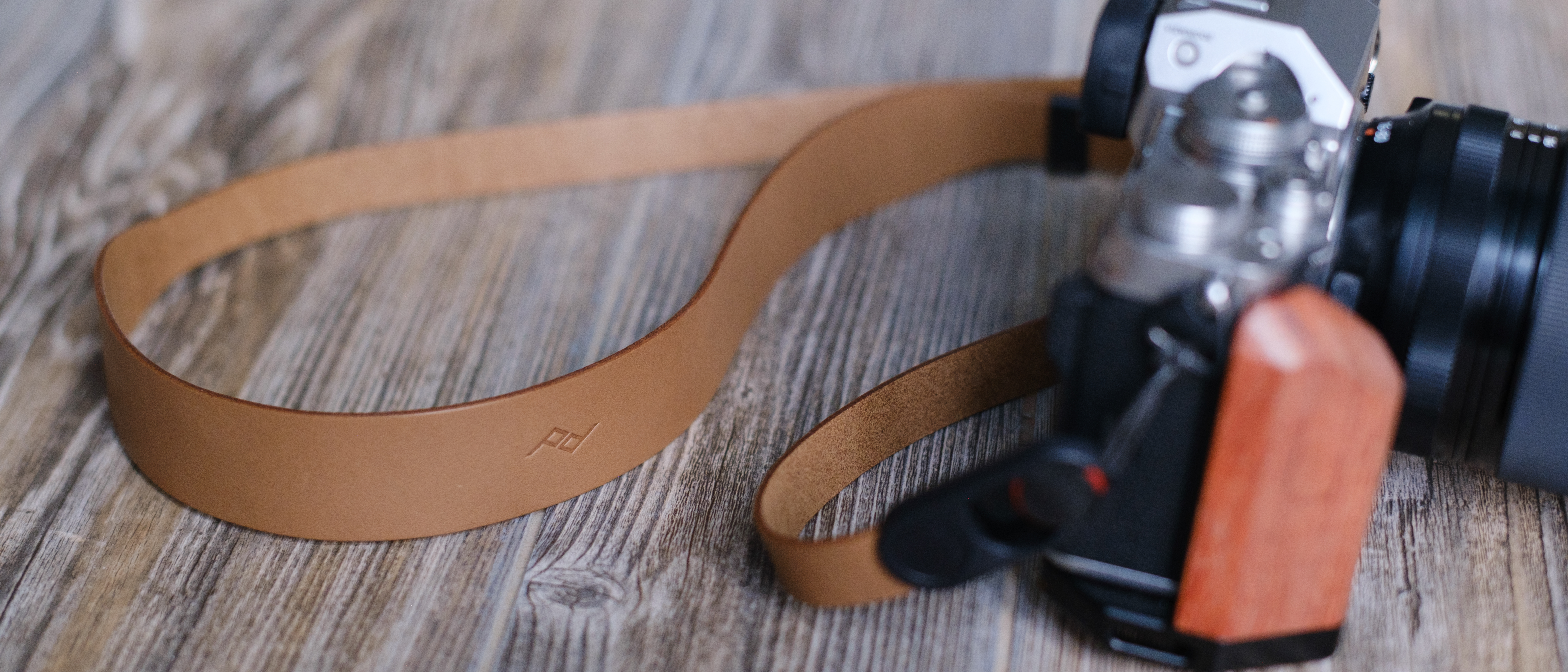 The Peak Design Form leather camera strap in the Amber color