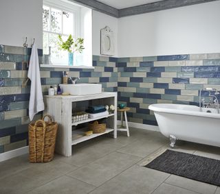 bathroom with gloss tiles and freestanding white bath