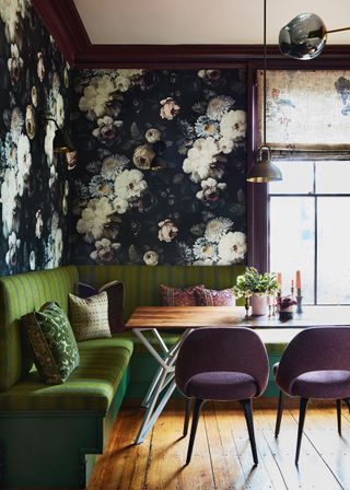 dining room with dark purple trims and seats, green banquette seat and ellie cashman floral wallpaper