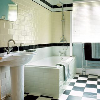 bathroom with chequered tiles and bathtub