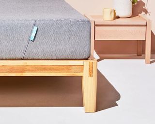 Siena Memory Foam Mattress on wooden bed frame beside pink nightstand