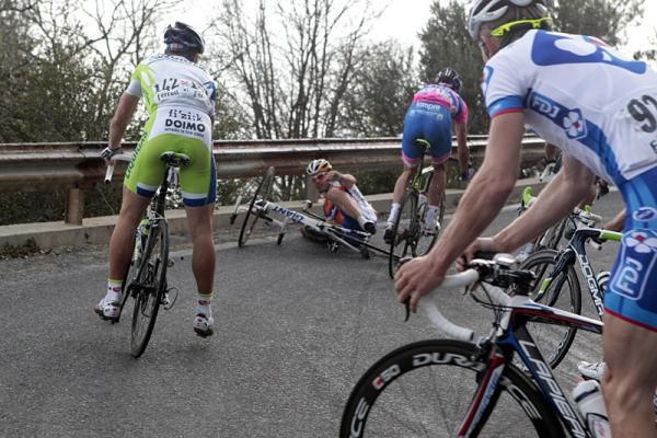 Riders make their way around Oscar Freire (Rabobank), who crashed on the descent of Le Manie.