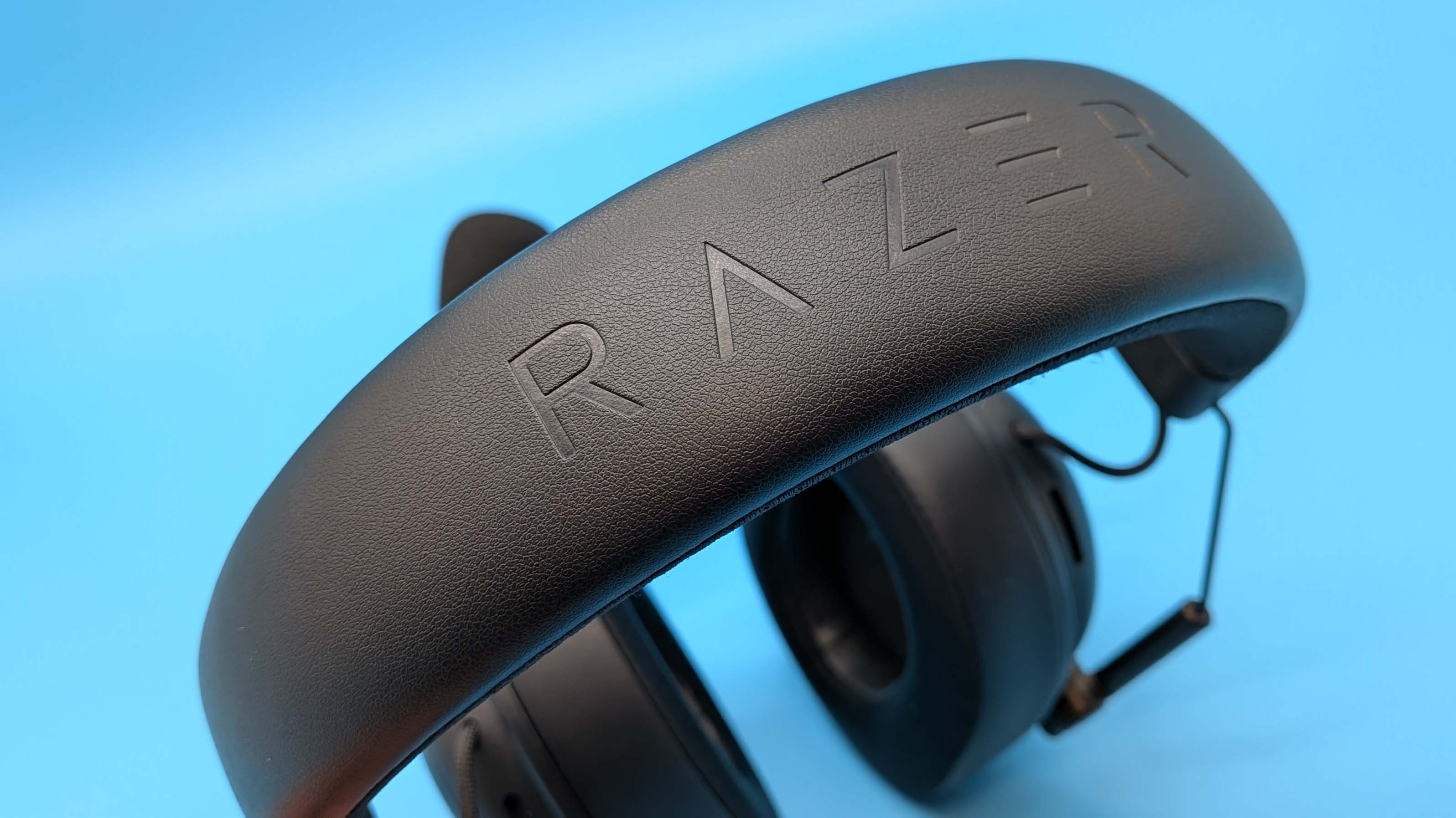 Razer BlackShark V3 gaming headset on a blue blackground