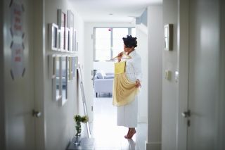 a woman trying on clothes - who is saving money when shopping with Amazon