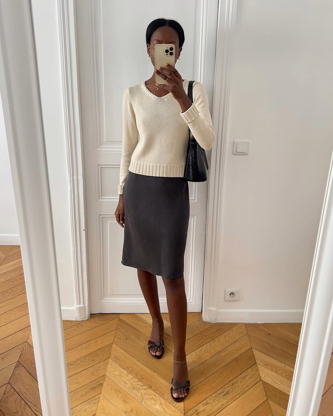 Sylvie mus wears a pencil skirt and jumper
