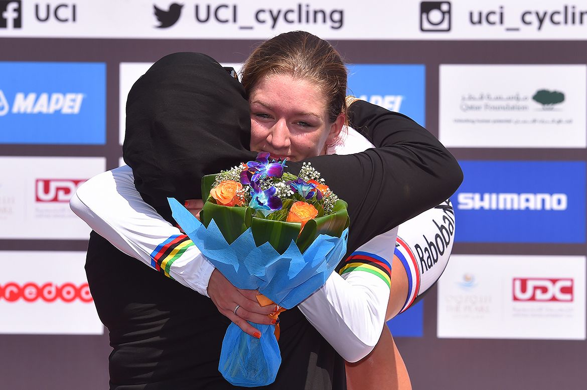 Karlijn Swinkels gives one of the podium presenters a big hug after receiving her medal and jersey