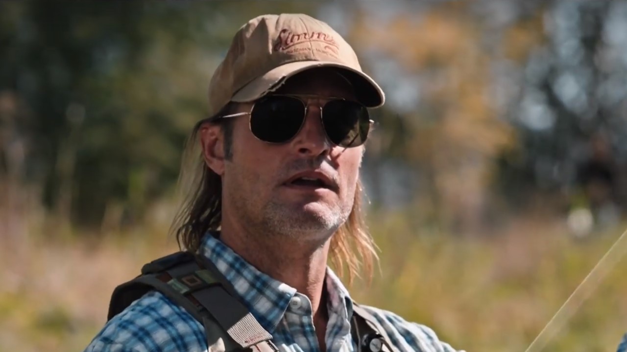 Roarke in sunglasses fishing on Yellowstone