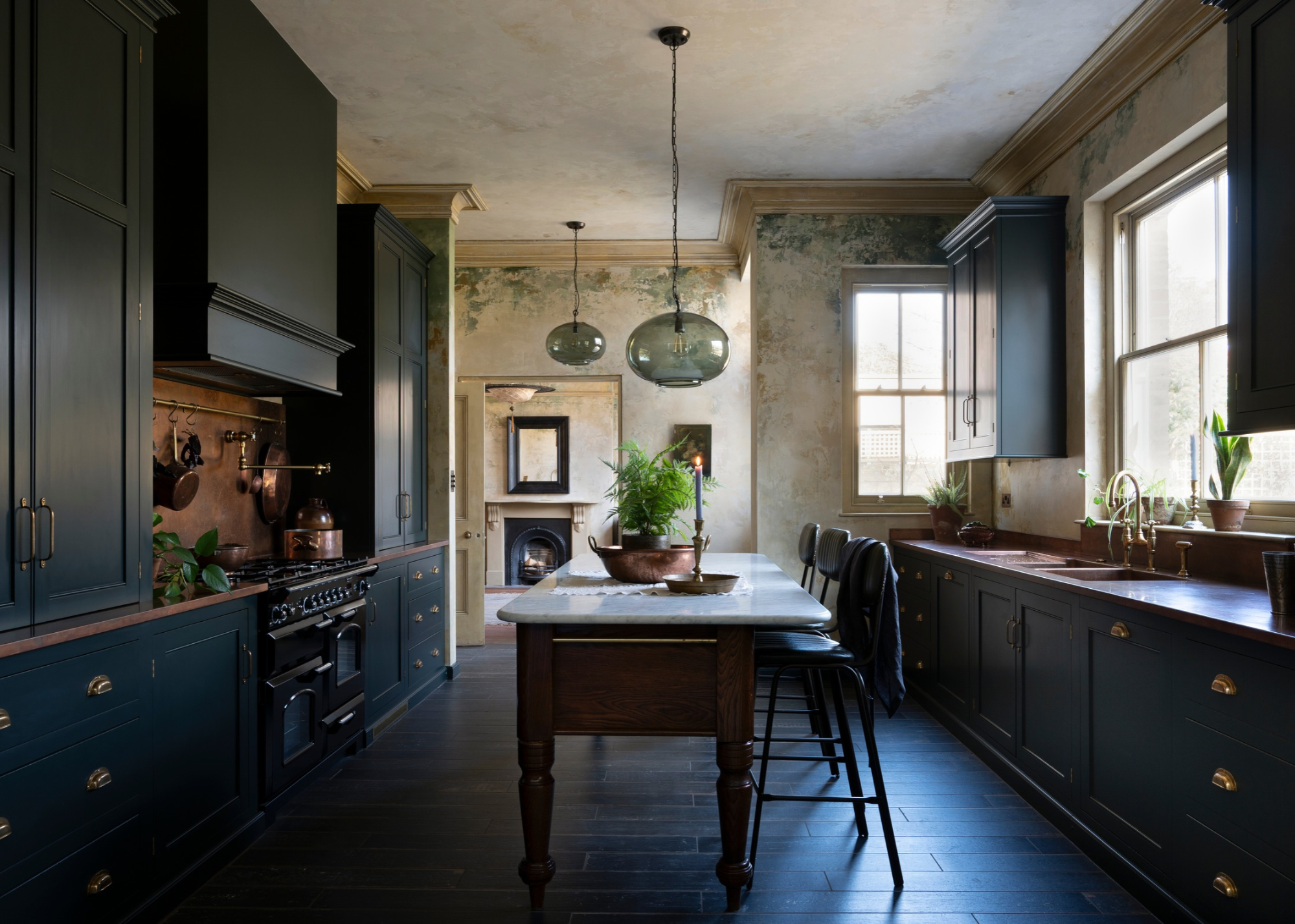 Traditional style kitchen with dark blue cabinetry and glass pendant lights