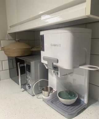 Cuisinart Soft Serve Ice Cream Maker in small white kitchen with stainless steel microwave, and beige colored Our Place Always 2.0 pan