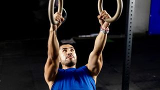 Man performing an Australian pull-up using gym rings during a back workout