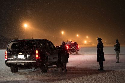 President Barack Obama's motorcade leaves Andrews Air Force Base amid snow fall on January 20, 2016 in Maryland. 