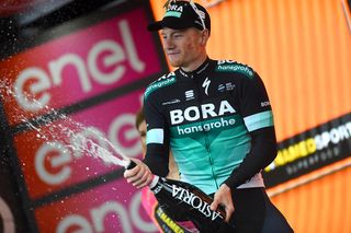 Sam Bennett (Bora-Hansgrohe) celebrates his stage 12 win on the podium at the Giro d'Italia