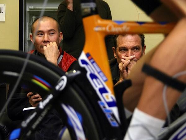 Allen Lim and Jim Felt look on intently as Vande Velde is set up.