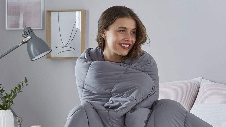 Person snuggled in Silentnight weighted blanket