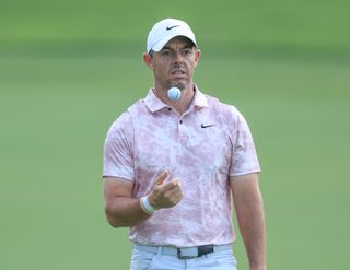 Rory McIlroy chucks his golf ball in the air and catches it