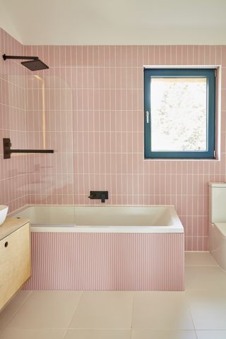 pink tiles bathroom with blue triple glazed windows