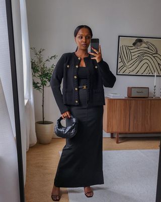 @femmeblk wearing a black boucle jacket and dress