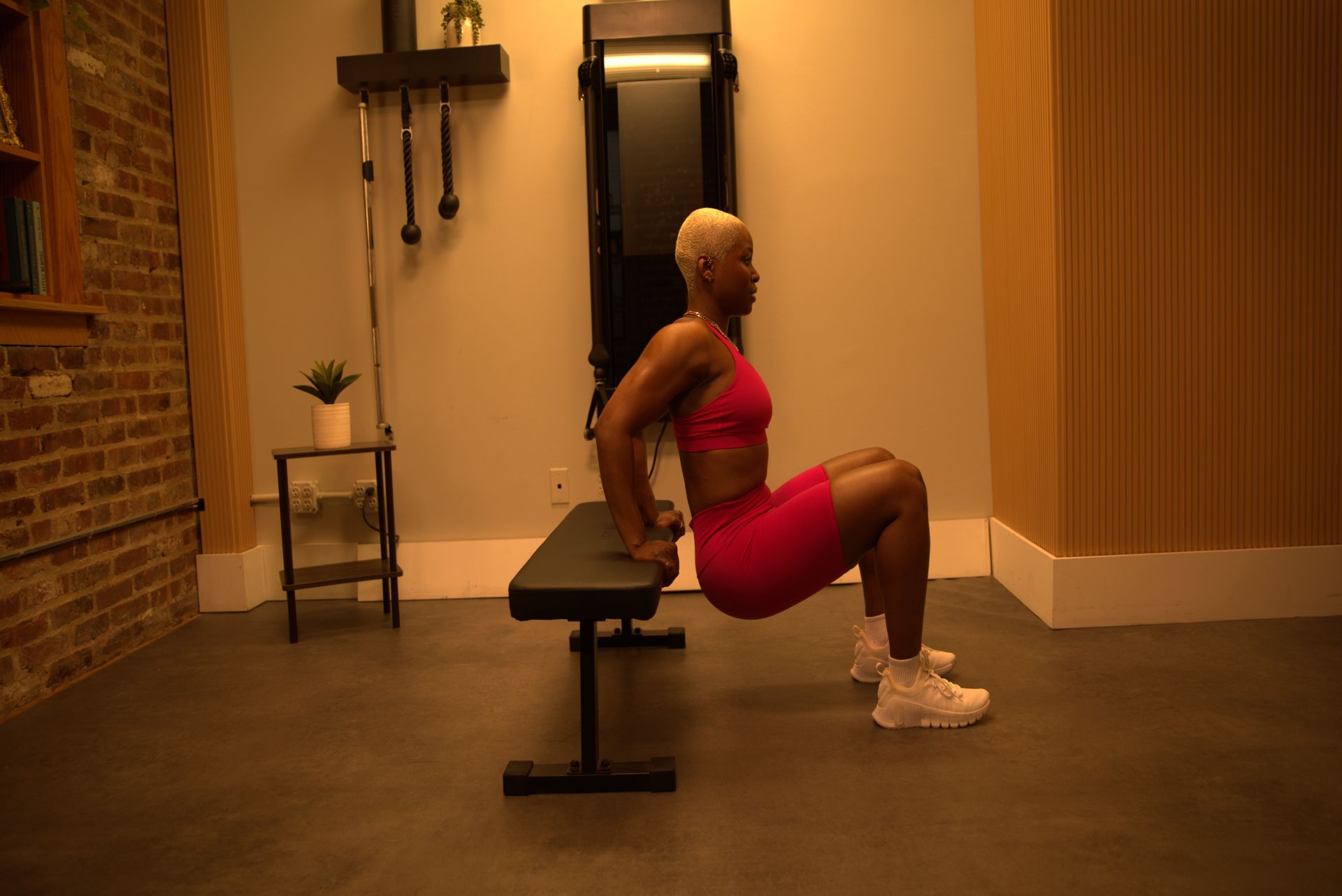 woman does tricep dip exercise using bench