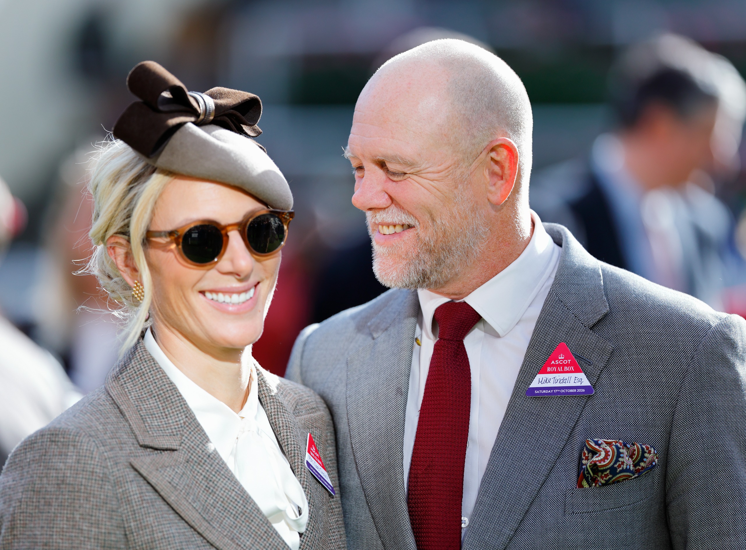 Mike Tindall wearing a gray suit smiling at Zara Tindall