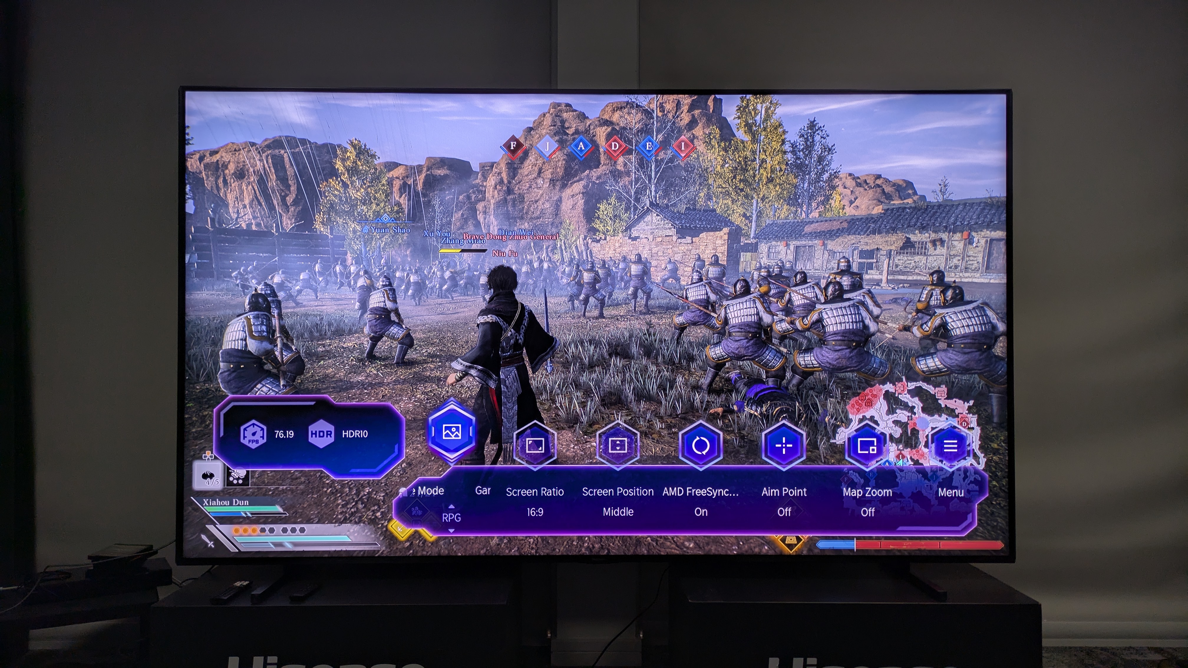 Hisense 116UX RGB mini-LED TV with Dynasty Warriors Origins and game bar on screen