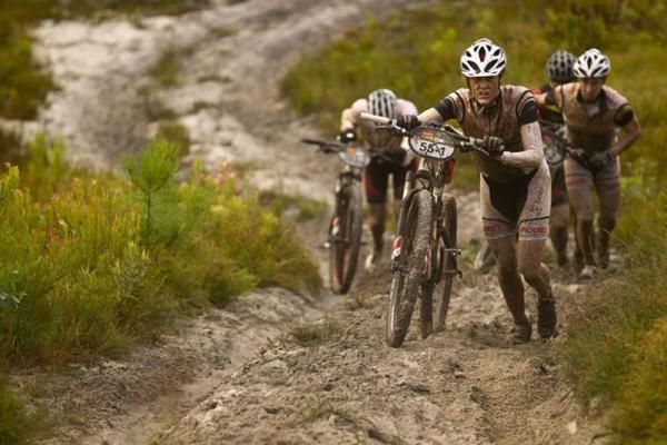 Theresa Ralph pushes through the sand during stage 5 of the 2012 Absa Cape Epic Mountain Bike stage race from the Overberg Primary &amp; High School in Caledon to Oak Valley Wine Estate in the Elgin Valley, South Africa on the 30 March 2012