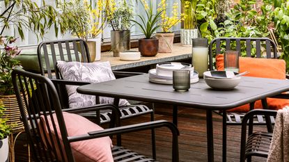 Black outdoor dining set with plates and dinnerware